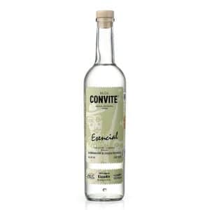 Bottle of Convite Esencial Espadín Mezcal displayed on a rustic wooden surface, reflecting its artisanal origin and clean, smoky character.