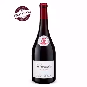 A sleek bottle of Louis Latour Valmoissine Pinot Noir 2023 placed beside a filled wine glass, showcasing its ruby hue—set against a soft, neutral background that hints at the French countryside and the wine’s refined character.